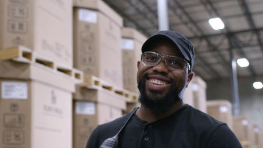 man wearing safety goggles smiling at camera 
