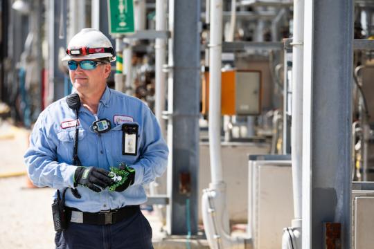 man wearing safety goggles smiling at camera 