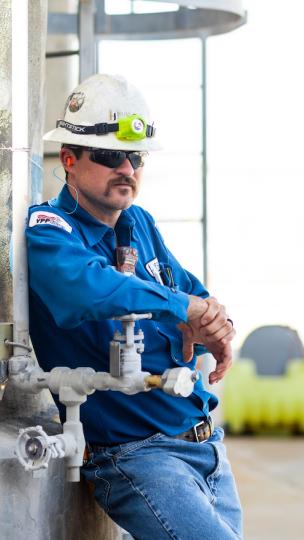 man in protective gear leaning and posing for camera